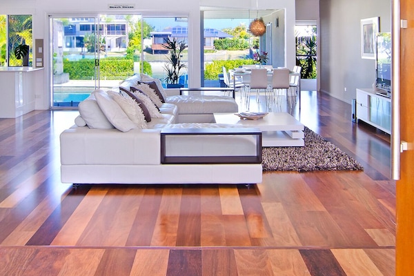 Open-plan lounge with water views and a new 85" 4K Smart TV with Netflix.