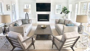 A modern living room with two sofas, a coffee table, and a fireplace. - Stunning In-Town Home With Stone Hot Tub - Plunge Pool (Nantucket)