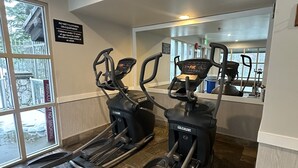 A gym with treadmills, stationary bikes, and a mirrored wall. - Aspens #439 Prime Ski-in Ski-out Location! Top Floor Unit, Pool, Hot tubs, BBQ (Whistler)