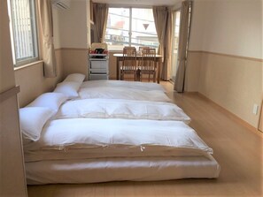 A room with a large bed, a desk, and a chair. - uenohouse annex (Tokyo)