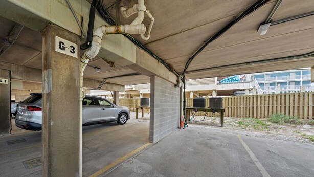 A covered parking area with concrete pillars marked 'G-3' and 'G-1'. - Sundial G3- The Beach is Where You Need to Be! (Gulf Shores)