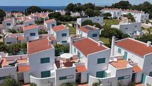 A coastal residential area with white buildings, red-tiled roofs, and green shutters. - L&A VILLA- with private Salt pool-3 bedrooms w/ AC, Heated Pool (optional) (Portimão)