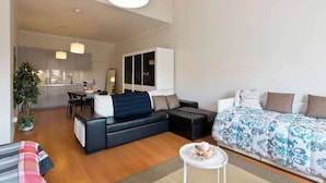 A modern apartment with a living room, a dining area, and a kitchen.