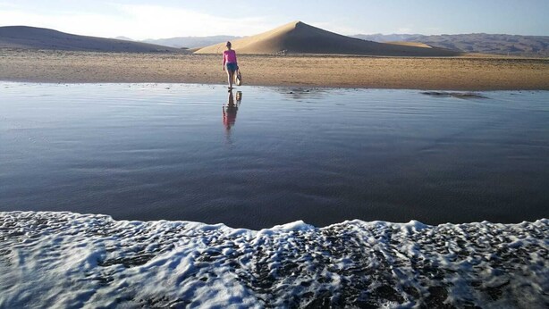 A person standing on a reflective surface with a mountainous landscape in the background. - SWEET DREAMS Beautiful Apartment. Light, Comfort, Tranquility (Sta Brígida)