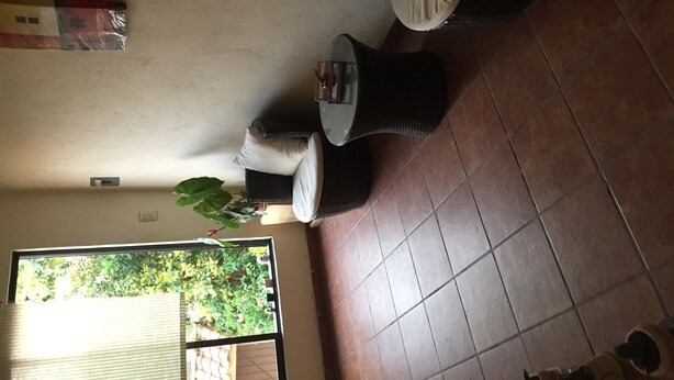 A room with a tiled floor, a window with blinds, a potted plant, and a small table with a chair. - Nice house in bugambilias extension (Jiutepec)