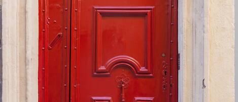 A red door with a keyhole and a number '19' above it.