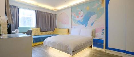 A bedroom with a bed, bedside tables, a desk, and a window with curtains.