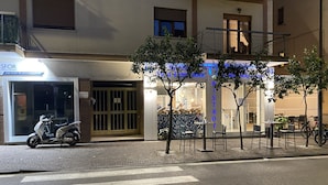A street view with a cafe named 'Pistot' and a scooter parked in front. - BeB Caruso (Sorrento)