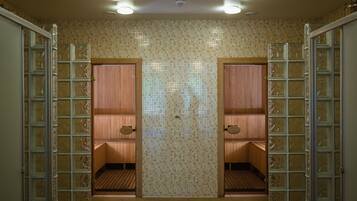 A sauna room with two wooden benches and glass partitions.
