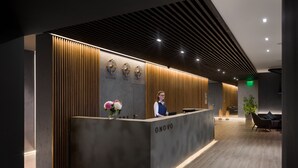 A reception desk with a modern design, featuring a dark grey color scheme and wooden paneling. - Onovo (Kyiv)