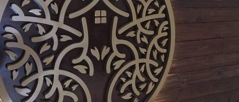 A wall-mounted decorative panel with intricate cut-out designs.