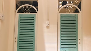 Two doors with a light blue color and a white frame. - KHA Hostel & Cafe (Ho Chi Minh City)