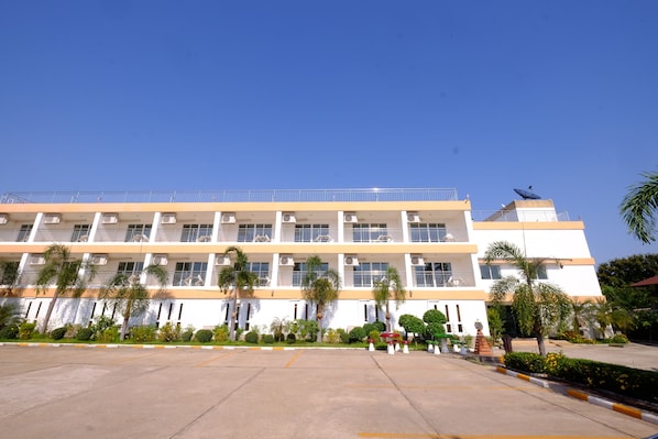 A multi-story building with a flat roof, large windows, and a parking lot in front. - Thatphanom River View Hotel (That Phanom)
