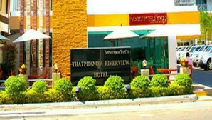 A hotel with a stone facade, a sign reading "Thaththanom Riverside Hotel," and a view of the surrounding area. - Thatphanom River View Hotel (That Phanom)