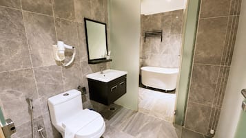 Un baño moderno con inodoro, lavamanos y bañera.