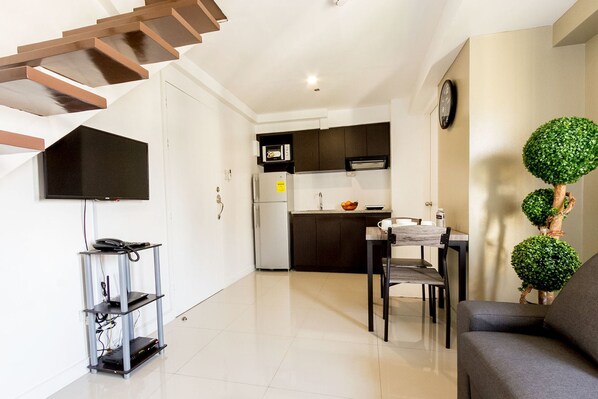 A modern apartment with a kitchen, dining area, and living room.