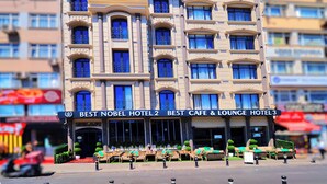 Een meerlaags hotel met balkons, een café en een lounge.