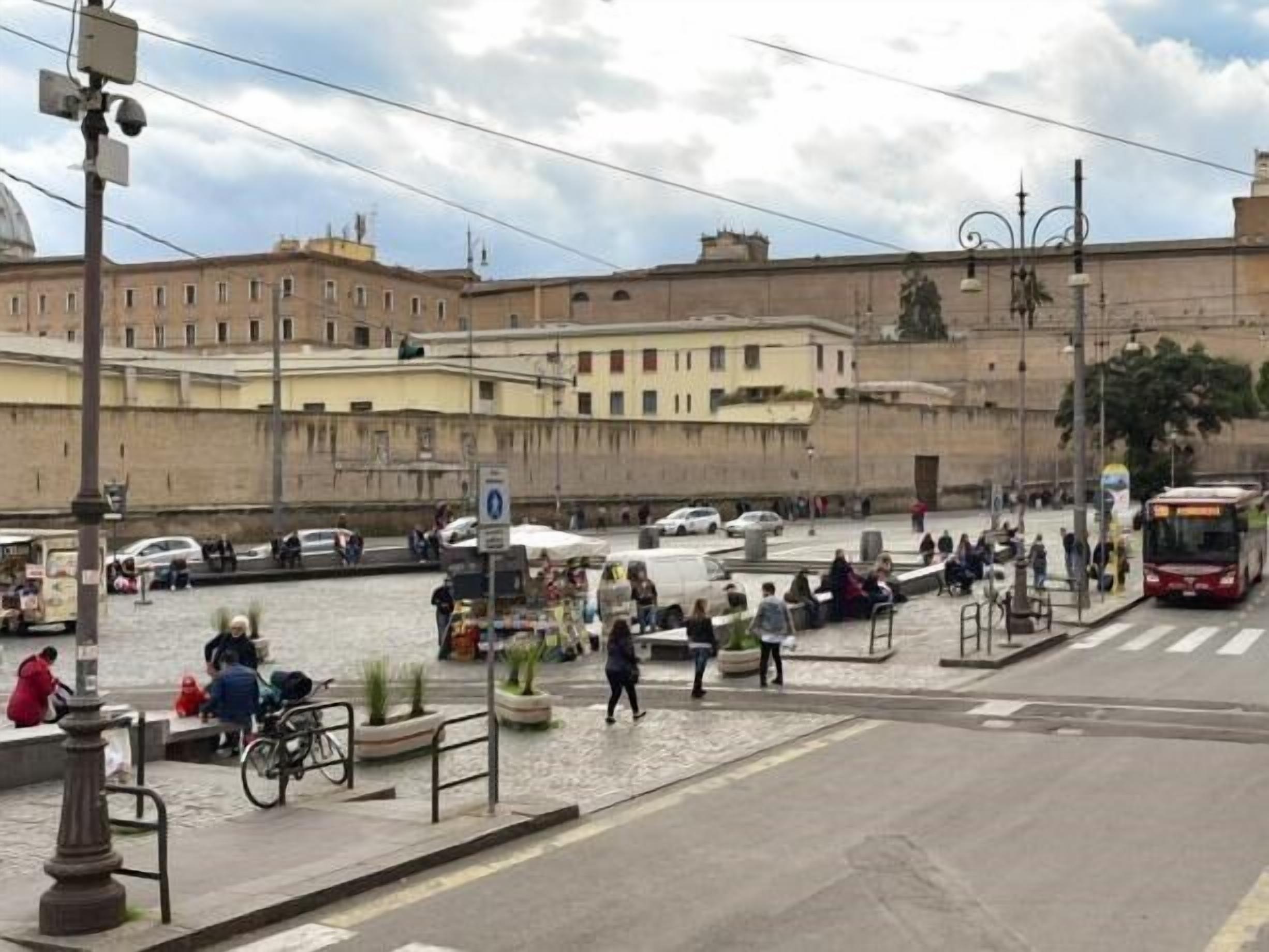 A busy urban street with a canal, buildings, and a bus.
