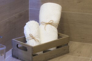 A wooden crate with two white towels tied with twine.