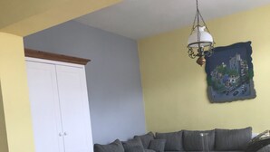 A living room with a sofa, a white coffee table, and a white wardrobe. - Families, groups, cycling, biking, hiking, vacation with dog, short vacation, Kyllradweg, (Stadtkyll)