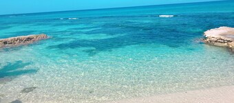 House by the sea with a small sandy beach, pool and fantastic views