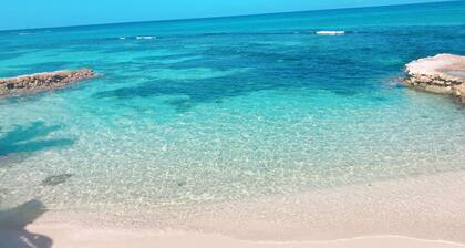 House by the sea with a small sandy beach, pool and fantastic views