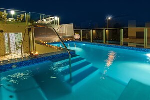 Una piscina al aire libre, sillones reclinables de piscina