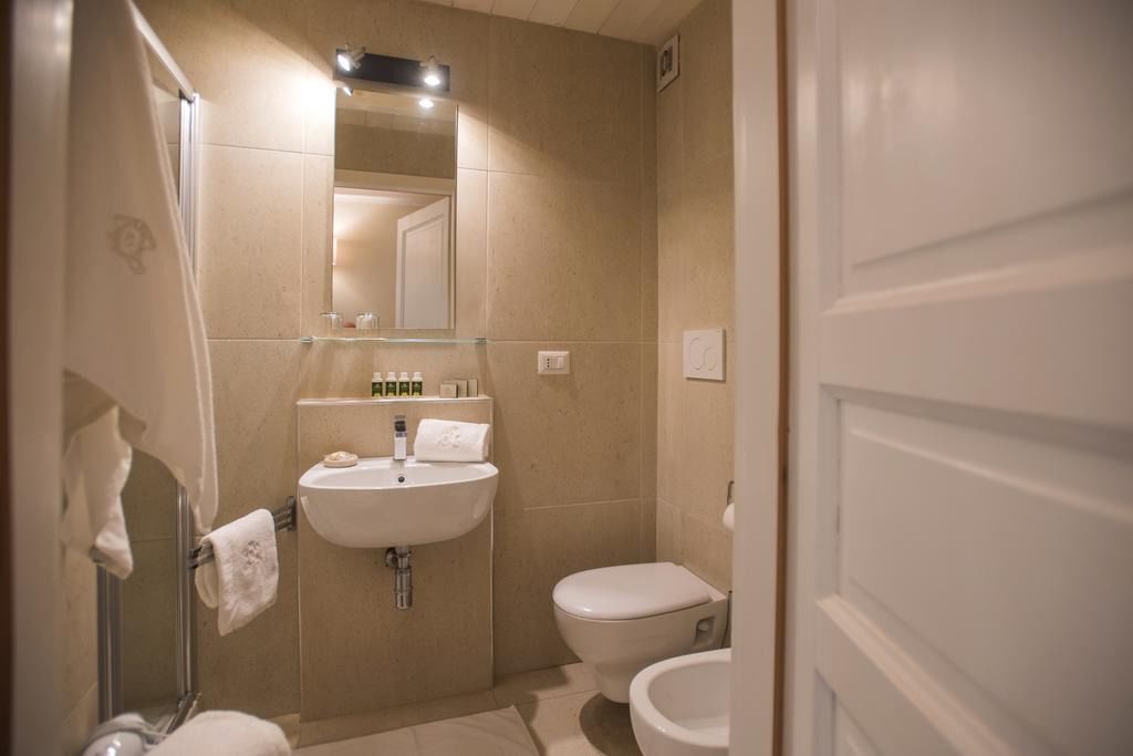 A bathroom with a sink, toilet, and shower.