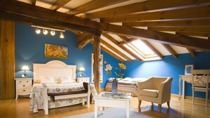 A bedroom with a bed, bedside tables, a chair, a desk, a window, and a skylight. - Posada La Rivera de Escalante (Escalante)