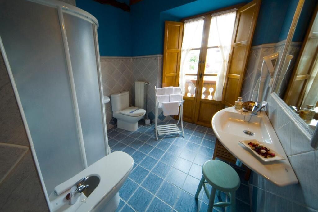 A bathroom with a bathtub, toilet, and sink.