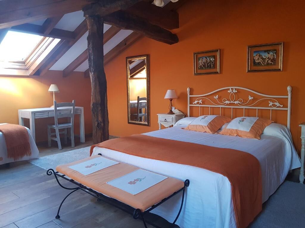 Un dormitorio con cama, escritorio y silla.