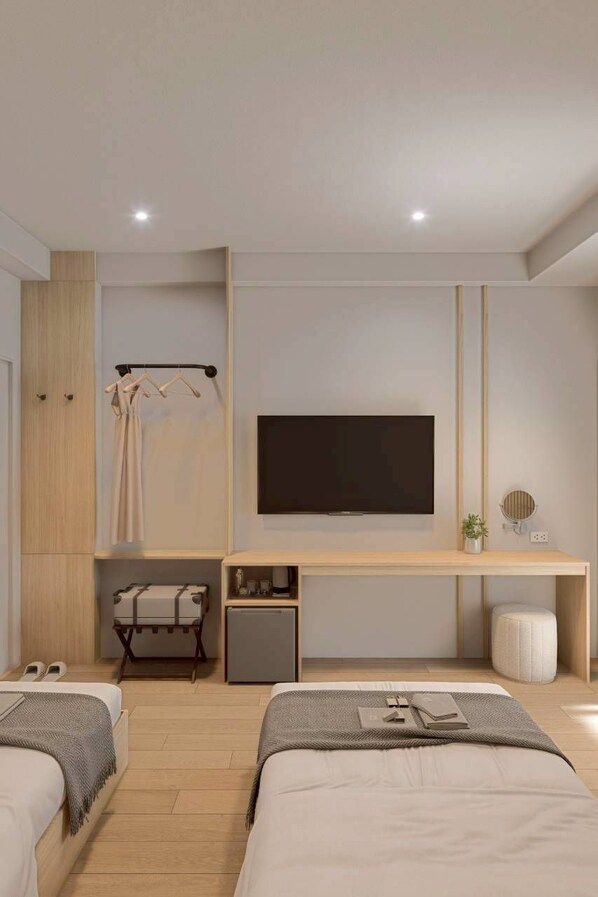Une chambre d’hôtel moderne équipée d’un lit, de tables de chevet, d’une télévision et d’une armoire.