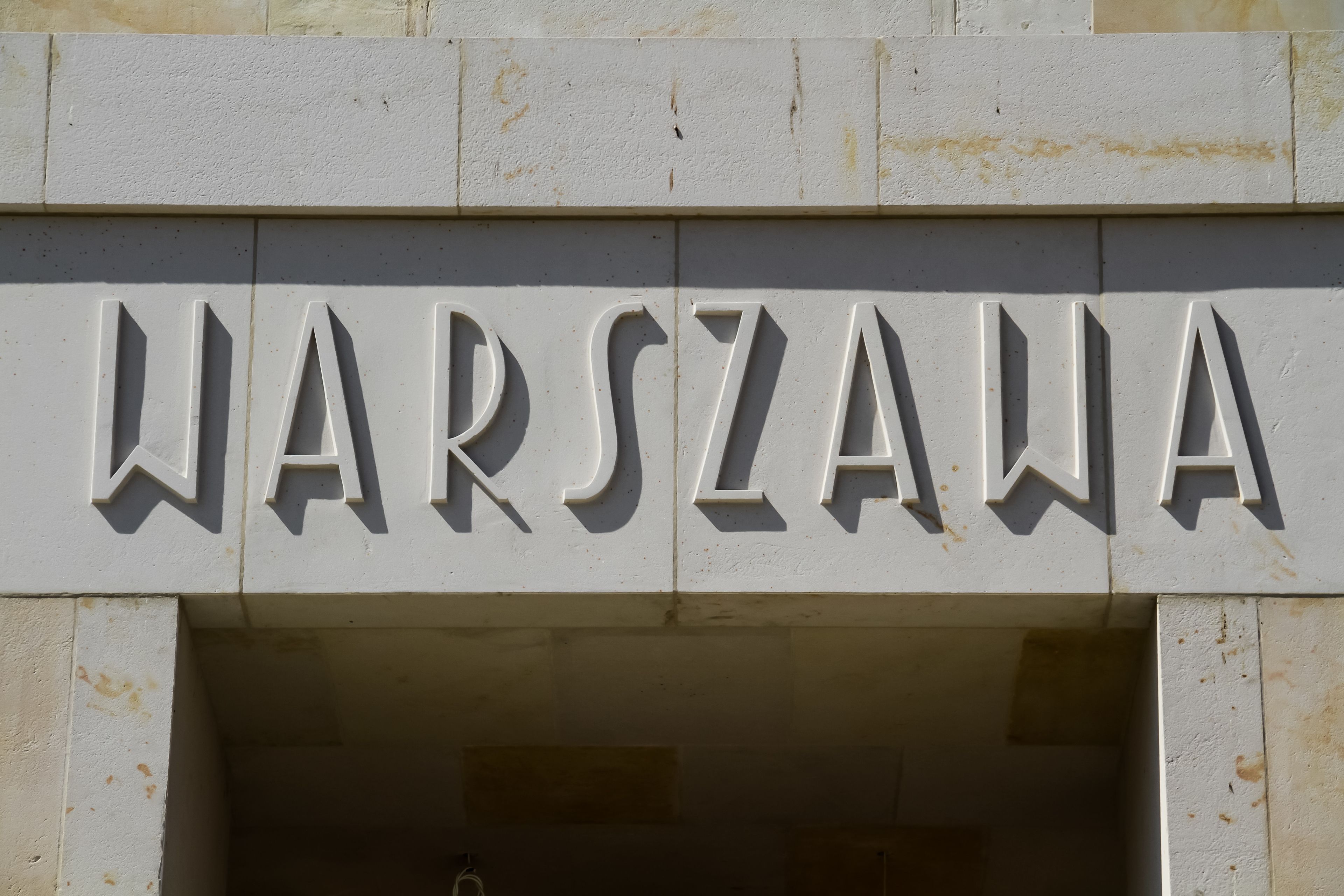 A sign with the word "WARSZAWA" in large, bold letters.