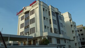 A multi-story hotel with a prominent "MANOR" sign on the top. - The Majestic Manor (Nagpur)