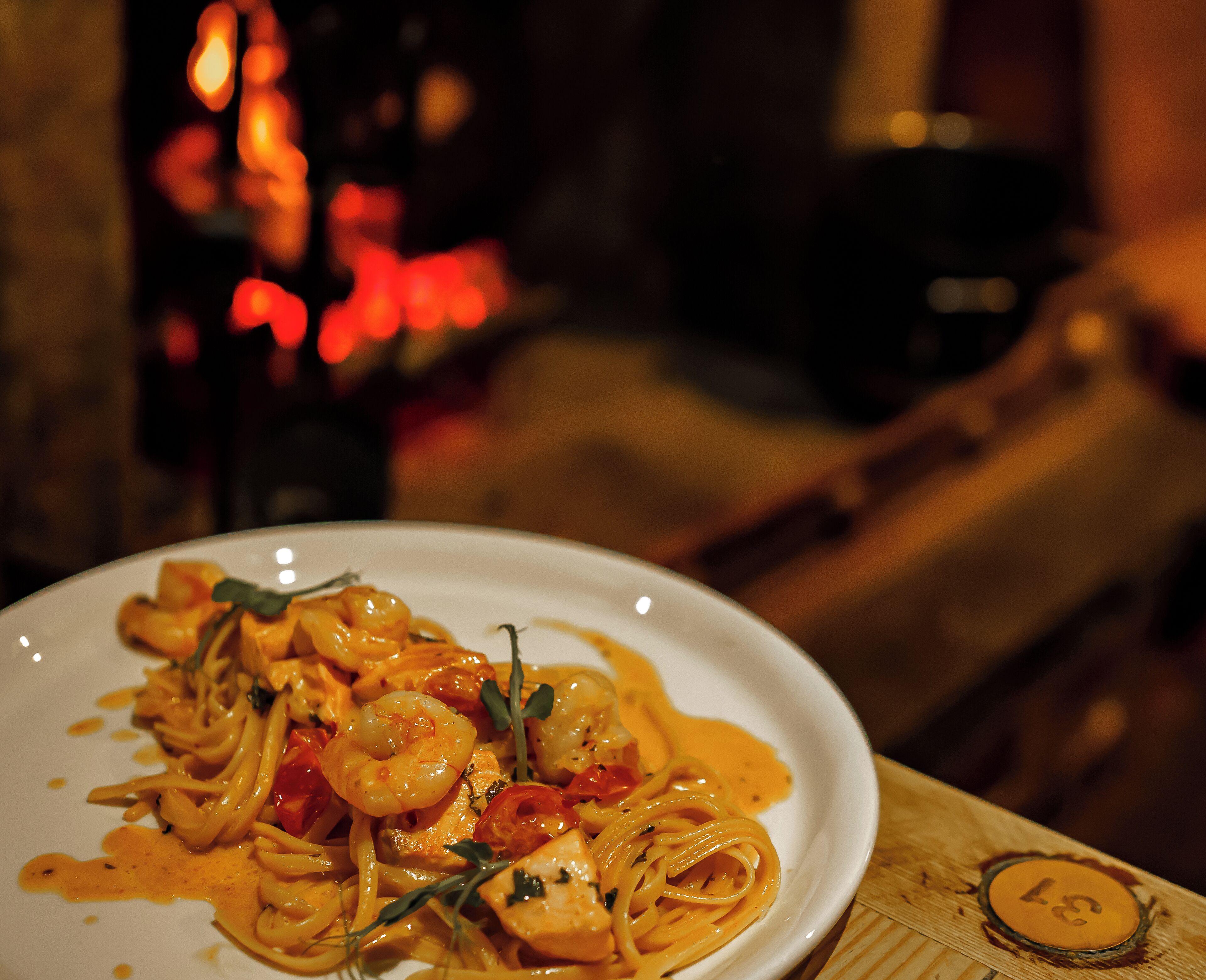 A plate of pasta with shrimp and vegetables.