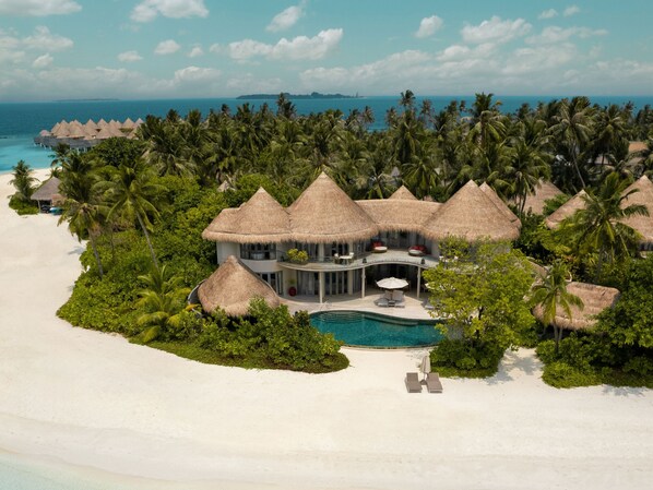 A resort with thatched-roof villas, a pool, and a beach. - The Nautilus Maldives (Thiladhoo)
