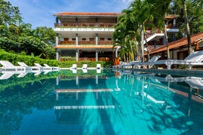 A hotel with a swimming pool, multiple balconies, and lush greenery. - Bauhinia Resort Phu Quoc  (Phu Quoc)
