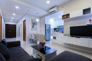 Relax in a spacious living area with a comfortable sofa set and flat-screen TV.