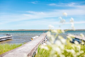 A wooden pier extending into a calm lake with a clear sky. - Fårösunds Semesterby (Fårösund)