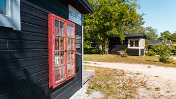 A black building with a red-framed window and a sign that reads "RECEPTION".