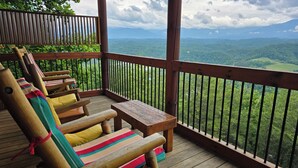 A wooden deck with a view of a mountainous landscape. - 'Mountainscape'-Million Dollar Views In Legacy Mtn. 10% off 7 night rental! (Pigeon Forge)
