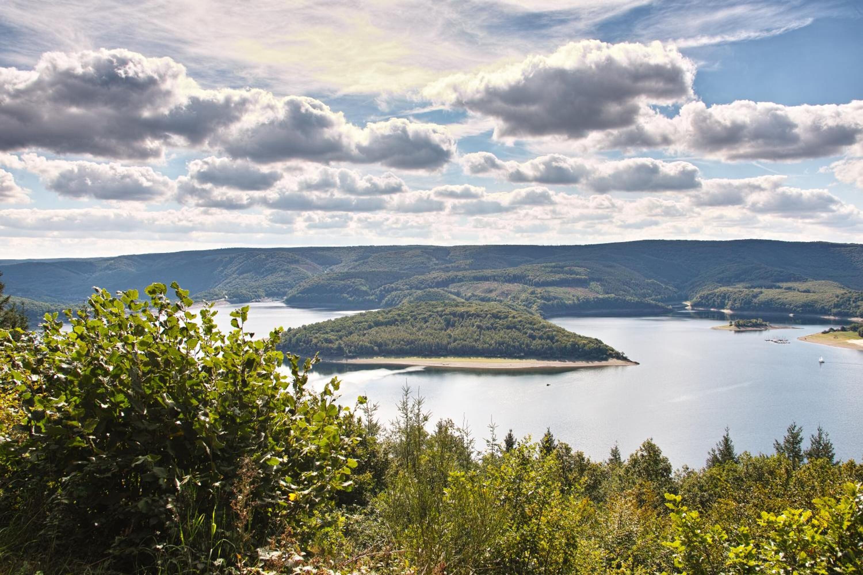 A lake surrounded by forested hills.
