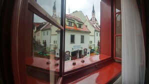 A window with a view of a building with a sign that reads "RESTAURANT DON JULIUS." - Mini Hotel Abraka (Cesky Krumlov)