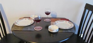 A dining table set with plates, bowls, and wine glasses. - (SEQUIM)