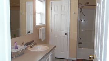 Bathtub, hair dryer, towels, soap