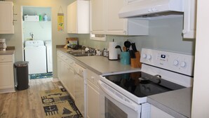 A kitchen with white cabinets, a stove, and a dishwasher. - LITTLE SLICE OF PARADISE !!! ONLY 3 miles to The Beach!!🏖 (supply)