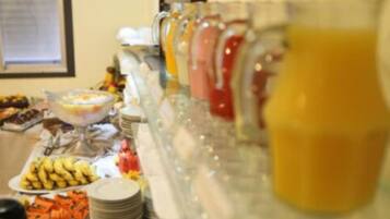 A buffet with various food items and beverages.