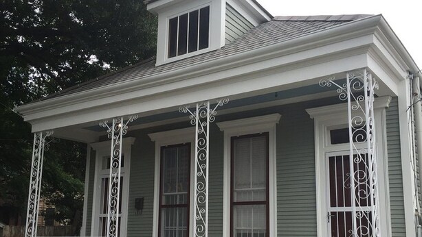 A two-story house with a covered porch and a small staircase leading to the entrance. - Classic Uptown Shotgun, Just Steps to the Streetcar ! (New Orleans)