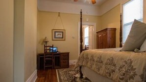 A bedroom with a bed, a desk, a chair, a ceiling fan, and a window. - Classic Uptown Shotgun, Just Steps to the Streetcar ! (New Orleans)