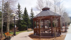 A gazebo with a wooden structure and a roof, surrounded by trees and a bench. - 3-bedroom condo in downtown Frisco - Near Lake Dillon.  (Frisco)